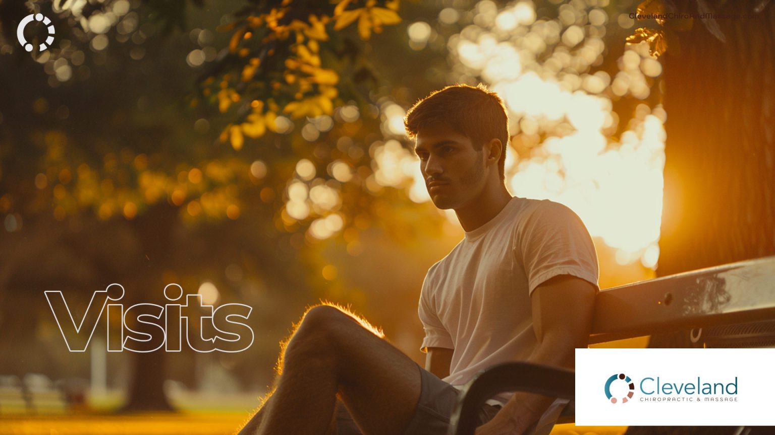 Visits - Young man sits at an outdoor bench in a park.